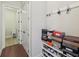 Functional hallway with built-in shoe rack and coat hooks, leading to a laundry area with a sink at 2420 Bronze Ct, Cumming, GA 30041