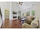 Bright living room features a fireplace, hardwood floors, large windows, and vaulted ceilings at 2420 Bronze Ct, Cumming, GA 30041