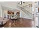 Open-concept living area with hardwood floors, staircase, kitchen view, and abundant natural light at 2420 Bronze Ct, Cumming, GA 30041