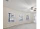 Bright living room with plush carpeting, a ceiling fan, and multiple windows for natural light at 2420 Bronze Ct, Cumming, GA 30041