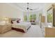 Spacious main bedroom with tray ceilings, large windows, and sitting area at 2420 Bronze Ct, Cumming, GA 30041
