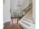 Staircase with carpet runner and dark wood railing, ascending to the second floor with view of living room at 2420 Bronze Ct, Cumming, GA 30041