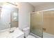 Bathroom with a sink and vanity, toilet, and shower with glass doors at 407 Robins Nest Ct, Woodstock, GA 30189