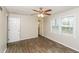 Bedroom with tile floors, a ceiling fan, and natural light from a window at 407 Robins Nest Ct, Woodstock, GA 30189