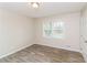 Neutral bedroom with wood-look floors and a large window at 407 Robins Nest Ct, Woodstock, GA 30189