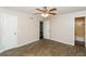 Spacious bedroom featuring tile flooring, ceiling fan, and ensuite bathroom at 407 Robins Nest Ct, Woodstock, GA 30189