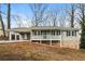 Charming home featuring a quaint front porch, stone accents, and convenient covered parking at 407 Robins Nest Ct, Woodstock, GA 30189