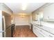 Kitchen features stainless steel appliances, granite countertops, and adjoins dining area at 407 Robins Nest Ct, Woodstock, GA 30189
