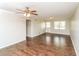 Bright living room with a ceiling fan and hardwood-style flooring at 407 Robins Nest Ct, Woodstock, GA 30189