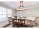 Dining room features wood floors, a large table, and natural light at 2352 Shore View Ct, Suwanee, GA 30024