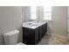 Bathroom with double vanity, marble countertop, and tiled floor at 4262 Buford Valley Way, Buford, GA 30518