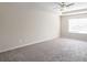 Spacious carpeted bedroom with ceiling fan and large window at 4262 Buford Valley Way, Buford, GA 30518