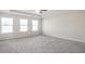 Large carpeted bedroom with multiple windows at 4262 Buford Valley Way, Buford, GA 30518