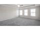 Bright bedroom with three windows and carpet at 4262 Buford Valley Way, Buford, GA 30518