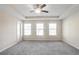 Spacious main bedroom with ceiling fan and windows at 4262 Buford Valley Way, Buford, GA 30518