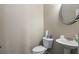 Small half bathroom with toilet and sink at 4262 Buford Valley Way, Buford, GA 30518