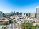 Expansive aerial view of the city featuring a mix of buildings, roads, and greenery under a clear blue sky at 3630 Peachtree Ne Rd # 2305, Atlanta, GA 30326