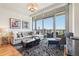 Bright living room featuring large windows with city views, a comfortable sofa, and stylish decor at 3630 Peachtree Ne Rd # 2305, Atlanta, GA 30326