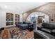 Open-concept living space featuring a brick archway and custom built-in shelving at 61 Alden Nw Ave, Atlanta, GA 30309
