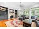 Spacious living room with fireplace, built-in shelves, hardwood floors, and access to backyard at 61 Alden Nw Ave, Atlanta, GA 30309