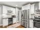 Well-equipped kitchen with stainless steel appliances, wine cooler, and white subway tile backsplash at 1375 Miller Reed Se Ave, Atlanta, GA 30315