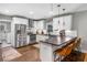Modern kitchen with stainless steel appliances, white cabinets, and a breakfast bar at 1375 Miller Reed Se Ave, Atlanta, GA 30315