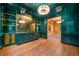 Stylish bar area with dark green walls, gold accents, and custom shelving at 3488 Tuxedo Nw Rd, Atlanta, GA 30305
