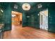 A sophisticated bar area featuring dark green walls and hardwood flooring at 3488 Tuxedo Nw Rd, Atlanta, GA 30305