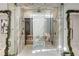 This opulent bathroom features a steam shower and sauna enclosed in glass, with marble walls and seasonal decor at 3488 Tuxedo Nw Rd, Atlanta, GA 30305