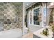 Well-decorated bathroom features a shower with decorative tile, seasonal accents, and bright natural light at 3488 Tuxedo Nw Rd, Atlanta, GA 30305