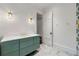 Bright bathroom featuring a stylish green vanity, elegant marble floors, and classic sconces at 3488 Tuxedo Nw Rd, Atlanta, GA 30305