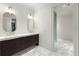 Modern bathroom with double vanity, marble floors, and sleek fixtures at 3488 Tuxedo Nw Rd, Atlanta, GA 30305