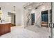 A luxurious bathroom featuring a marble shower and sauna, a wood vanity with marble countertop, and patterned floors at 3488 Tuxedo Nw Rd, Atlanta, GA 30305