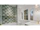 Charming bathroom featuring stylish tiles, a soaking tub and a large window providing natural light at 3488 Tuxedo Nw Rd, Atlanta, GA 30305