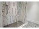 Luxurious shower featuring marble walls, mosaic flooring, and a sleek glass enclosure at 3488 Tuxedo Nw Rd, Atlanta, GA 30305