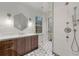 Bright bathroom with a glass shower, stylish vanity, and hexagonal mirror at 3488 Tuxedo Nw Rd, Atlanta, GA 30305