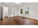 Spacious room with hardwood floors, white trim, and doorway to an adjacent bathroom at 3488 Tuxedo Nw Rd, Atlanta, GA 30305