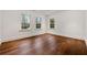Empty bedroom with pristine white walls and rich hardwood flooring, illuminated by natural light at 3488 Tuxedo Nw Rd, Atlanta, GA 30305
