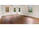 Empty bedroom features beautiful hardwood floors and multiple bright windows at 3488 Tuxedo Nw Rd, Atlanta, GA 30305