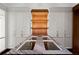 A custom closet featuring a stone countertop island with custom lighting at 3488 Tuxedo Nw Rd, Atlanta, GA 30305