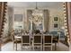 A dining room featuring botanical wallpaper, elegant chandelier, and seating for eight at 3488 Tuxedo Nw Rd, Atlanta, GA 30305