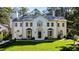 Elegant home with a manicured lawn, symmetrical facade, and detailed architectural features at 3488 Tuxedo Nw Rd, Atlanta, GA 30305