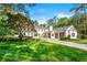 Beautiful home featuring a well-manicured lawn, mature trees, and a three-car garage, offering a perfect blend of elegance at 3488 Tuxedo Nw Rd, Atlanta, GA 30305