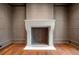 Classic fireplace featuring herringbone tile, custom mantel, and elegant wall paneling at 3488 Tuxedo Nw Rd, Atlanta, GA 30305