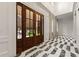 Elegant foyer featuring marble floors, high ceilings, detailed moldings, and grand wood doors at 3488 Tuxedo Nw Rd, Atlanta, GA 30305