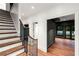 Bright foyer featuring hardwood stairs with iron railings, hardwood floors, and access to several rooms at 3488 Tuxedo Nw Rd, Atlanta, GA 30305