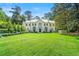 Stately white home with a large front yard, mature trees, and meticulous landscaping at 3488 Tuxedo Nw Rd, Atlanta, GA 30305