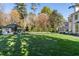Spacious front yard view featuring a well-manicured lawn, a guest house, and partial view of a white home at 3488 Tuxedo Nw Rd, Atlanta, GA 30305
