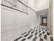 Hallway with high ceilings, elegant marble floors, white paneled walls, and staircase at 3488 Tuxedo Nw Rd, Atlanta, GA 30305