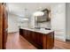 Modern kitchen with marble countertop island, custom hood, and wood floors at 3488 Tuxedo Nw Rd, Atlanta, GA 30305